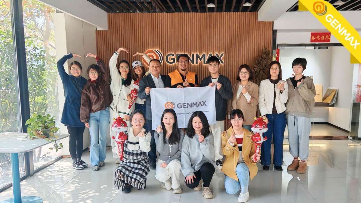 Major textile industry representatives from Guatemala posing for a commemorative group photograph with company executives at the quilting machinery manufacturing headquarters following their facility tour.