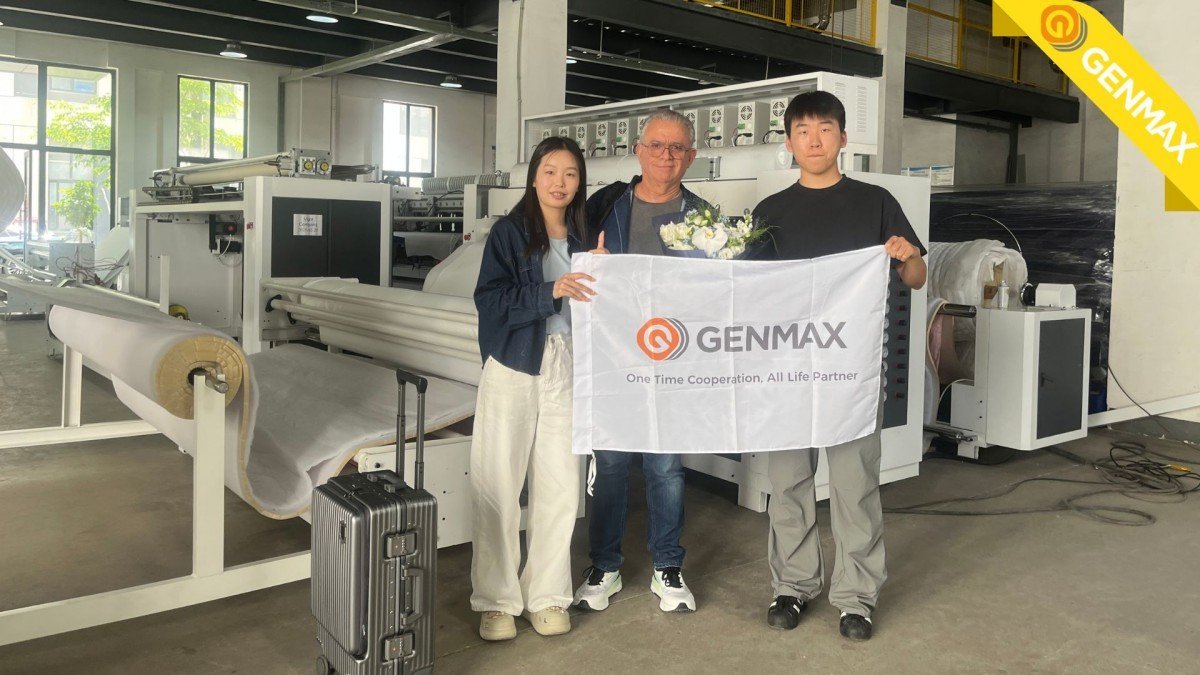 Technical specialists and Mexican textile entrepreneur posing for a commemorative photograph in front of the latest ultrasonic quilting machine model during a successful factory demonstration.