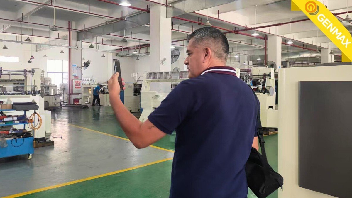Textile entrepreneurs from Peru carefully inspecting the technical components of industrial quilting machines during their evaluation visit to the manufacturing facility.