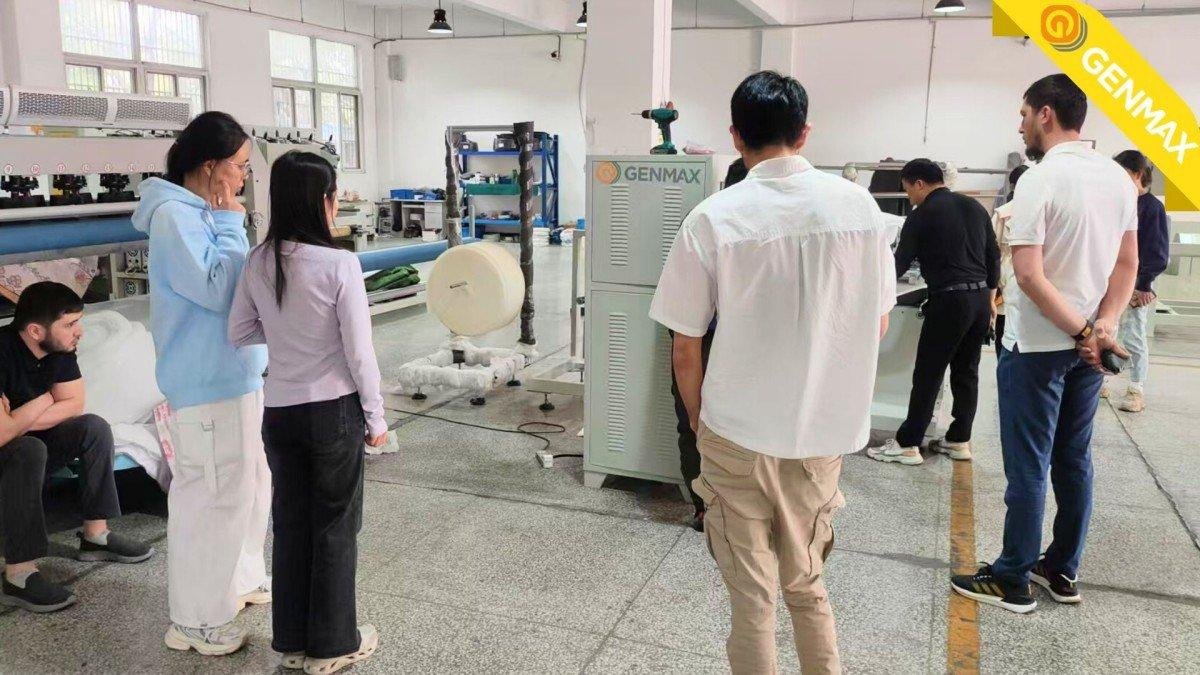 Industrial representatives from Uzbekistan carefully inspecting small ultrasonic quilting machines during their technical assessment visit to the manufacturing facility.
