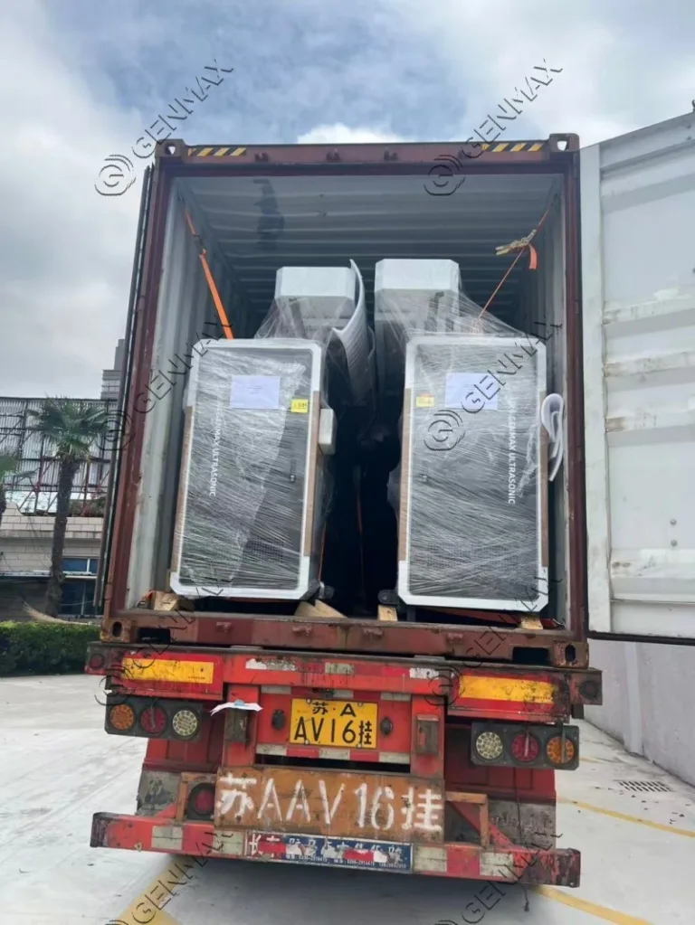Commercial ultrasonic quilting machinery wrapped in protective material awaiting shipment