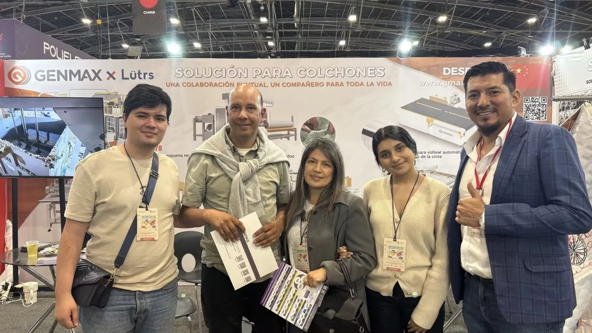 GENMAX team conducting an in-depth business consultation with multiple industry professionals seated around a table at the GENMAX x Lütrs booth, Interzum Bogotá 2026